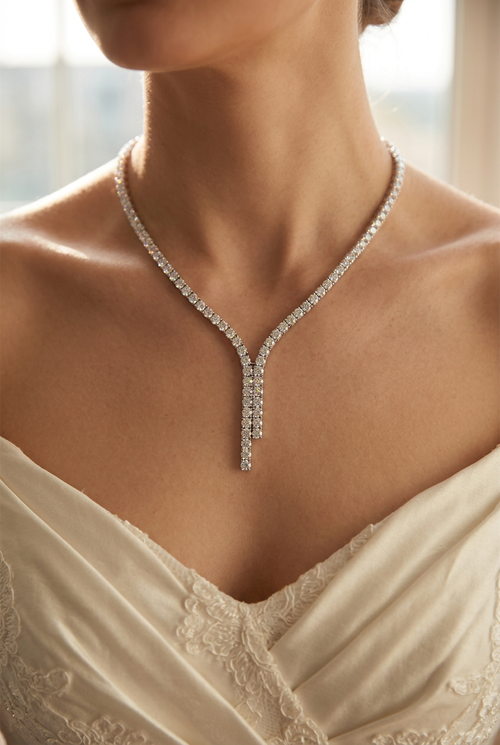 Bridal 4mm VVS moissanite tennis chain necklace in 925 sterling silver worn by a bride, close-up at the collarbone, warm natural light
